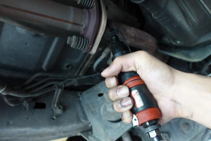 a person is holding a wrench in their hand
